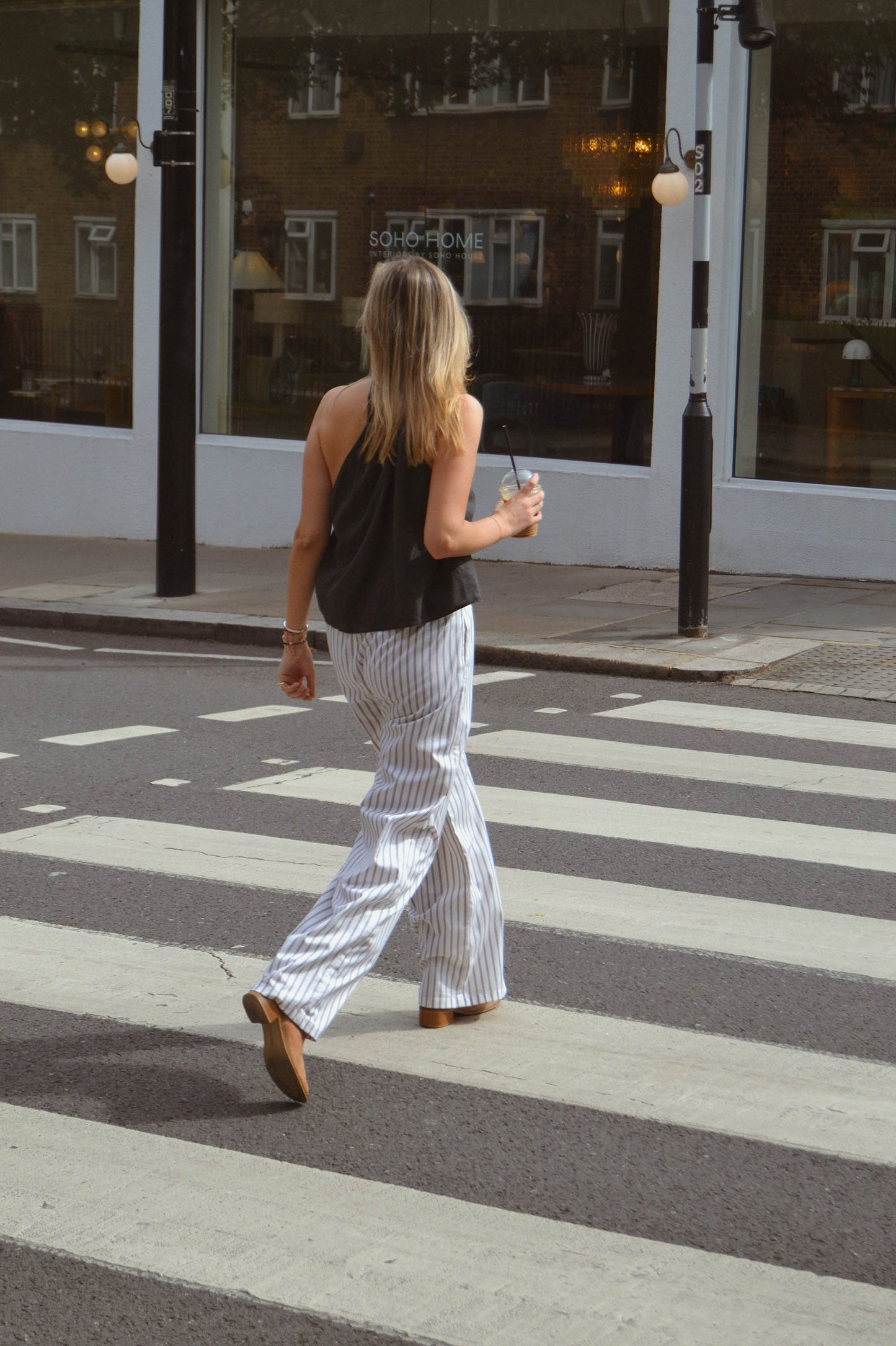 Woman walking on a zebra crossing in an urban setting